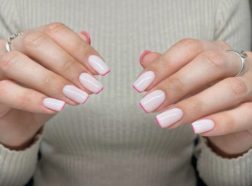 Milky white square nails finished with a fine pink French tip