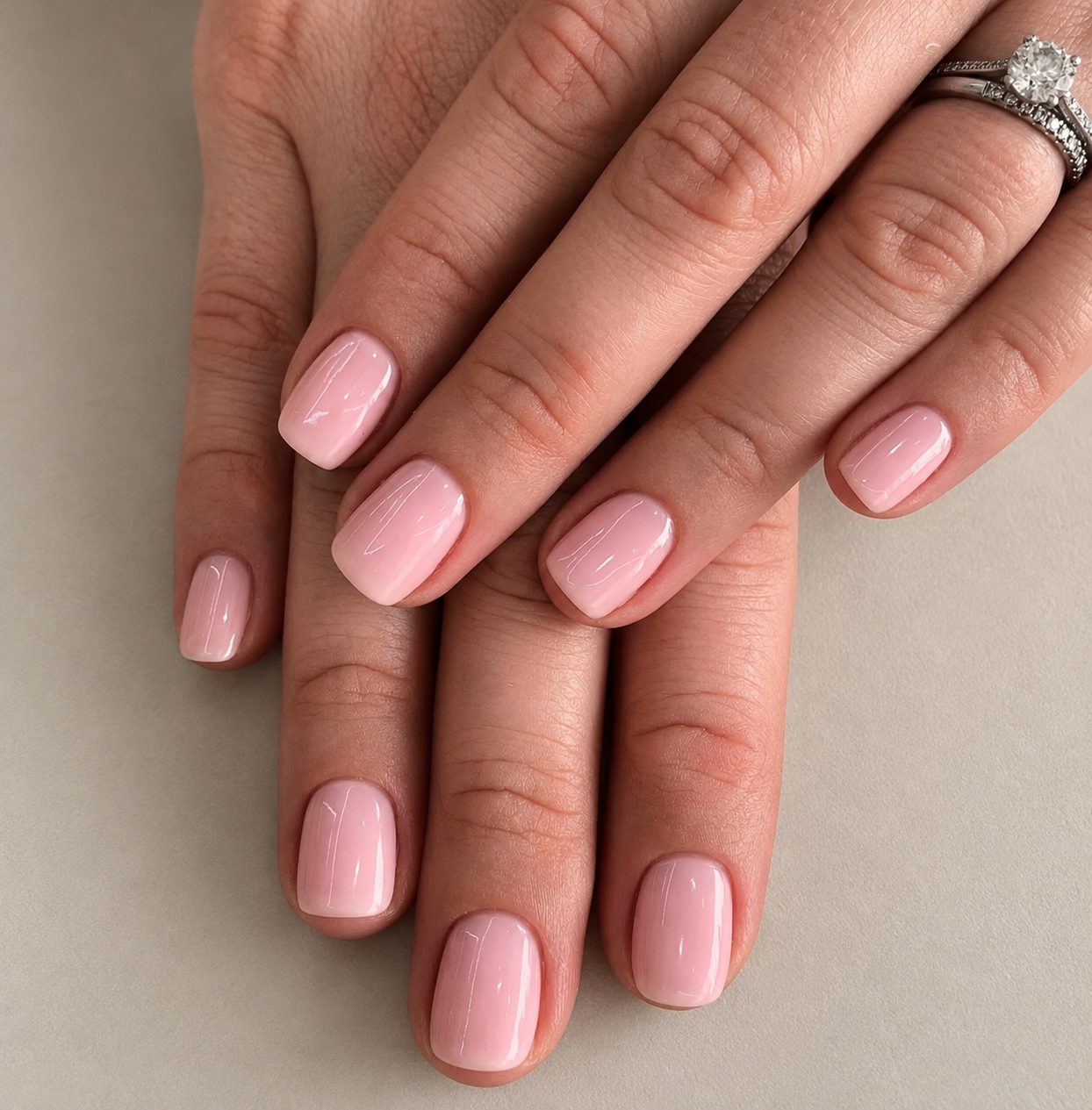 A soft pink gel manicure on short square nails